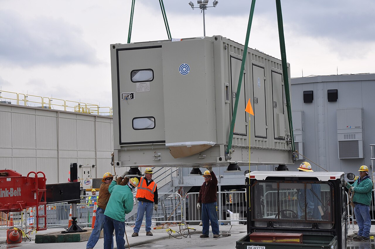 Industrial air compressor package being lifted into place at a processing plant